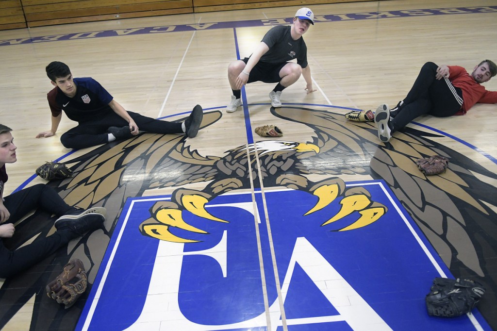 Erskine baseball players stretch in the school's gym Monday afternoon in South China. Monday marked the first day pitchers and catchers could start practicing.