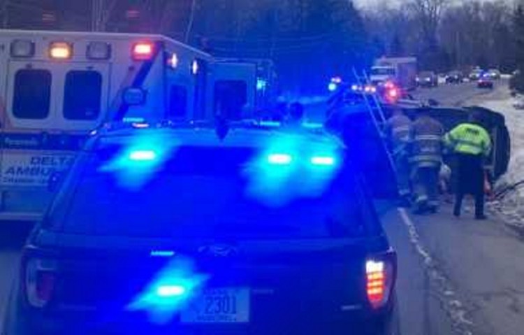 A crew work Thursday morning at the scene of a vehicle rollover on China Road in Winslow. The driver involved in the accident was not injured.