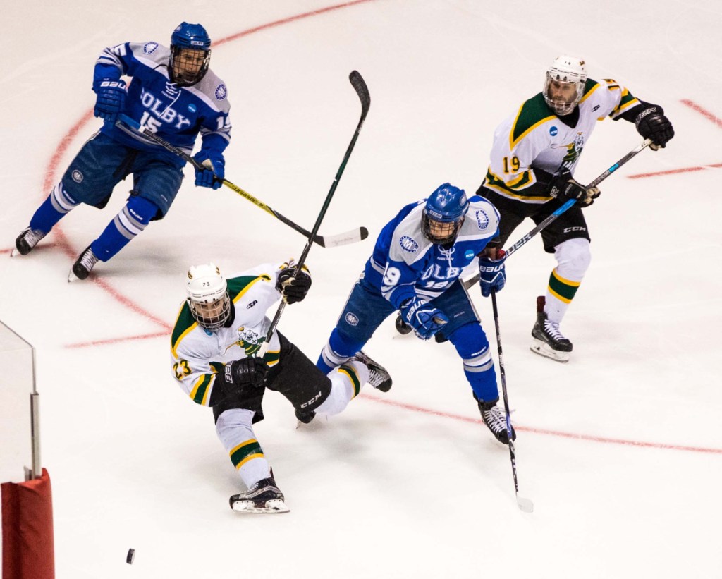 Colby's Zack Hale looks to fend off Erik Cooper of St. Norbert College during an NCAA men's hockey Division III Frozen Four game Friday in Lake Placid.