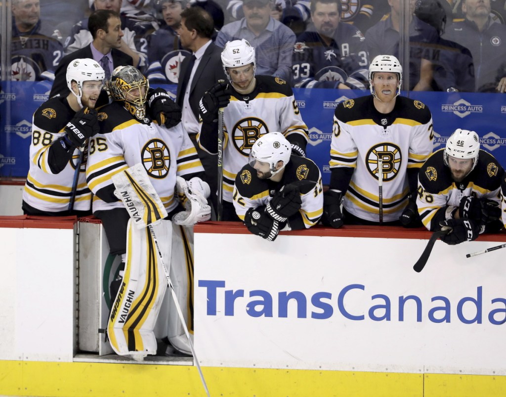 Boston forward David Pastrnak (88) and goaltender Anton Khudobin (35) stand on the Bruins bench during the shootout against the Winnipeg Jets on Tuesday.