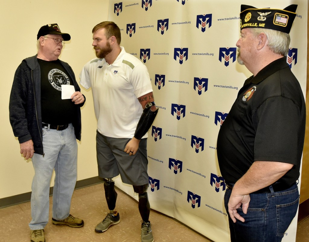 Veterans advocate Travis Mills, center, chats with Vietnam War veteran Bob DeBoer, left, and veteran Jeff Flye during a National Vietnam Veterans Day celebration Thursday in Waterville.