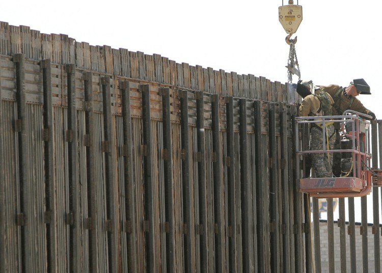 Utah National Guard soldiers work on extending a border fence in San Luis, Ariz., in 2006. President Trump plans to use the National Guard to secure the U.S.-Mexico border.