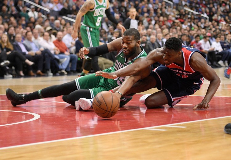 Washington's Ian Mahinmi, right, battles for the ball with Boston's Greg Monroe in the first half Tuesday at Washington.