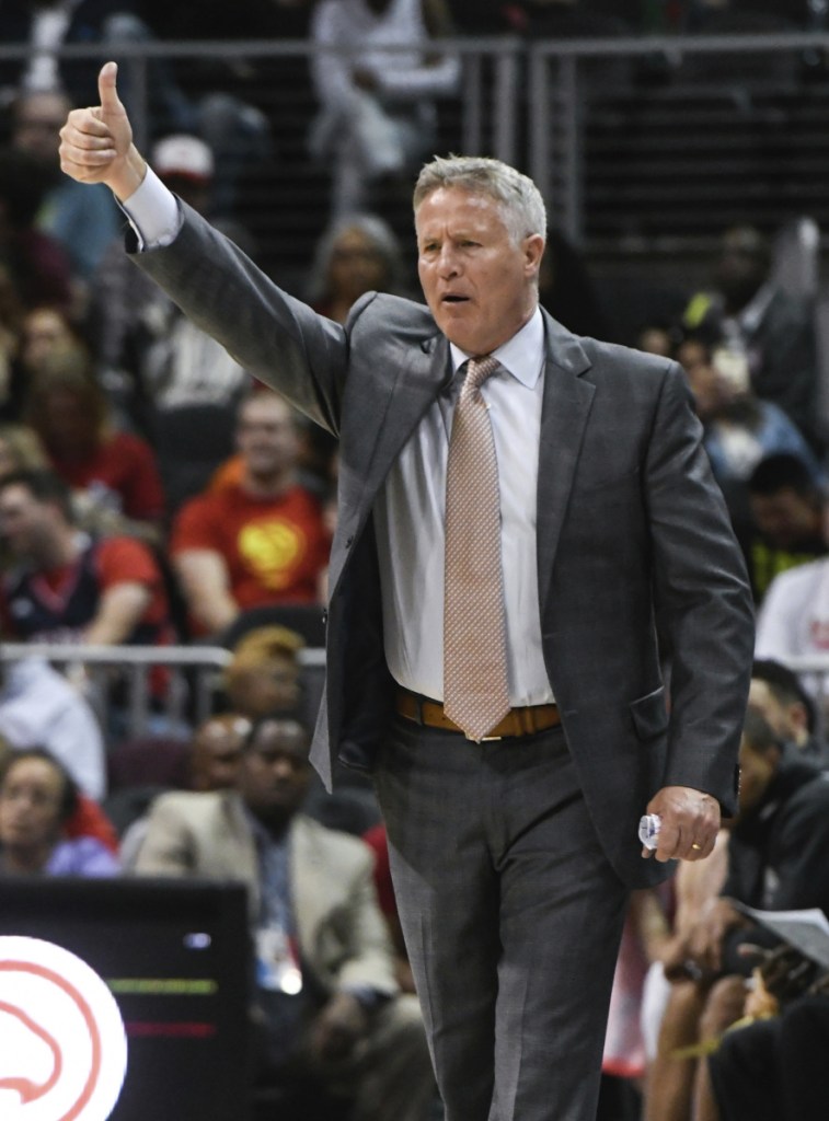 Philadelphia 76ers coach Brett Brown signals players during the second half of an NBA basketball game against the Atlanta Hawks Tuesday, April 10, 2018, in Atlanta. Philadelphia won 121-113. (AP Photo/John Amis)
