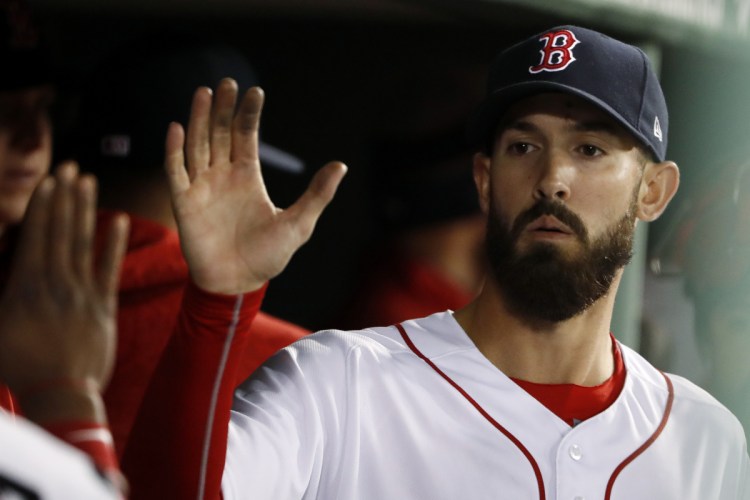 Boston Red Sox starting pitcher Rick Porcello is congratulated in the dugout after leaving after the seventh inning Thursday night against New York. Porcello took a no-hitter into the seventh inning, losing it on a lead off double to Aaron Judge, in Boston's 6-3 win.