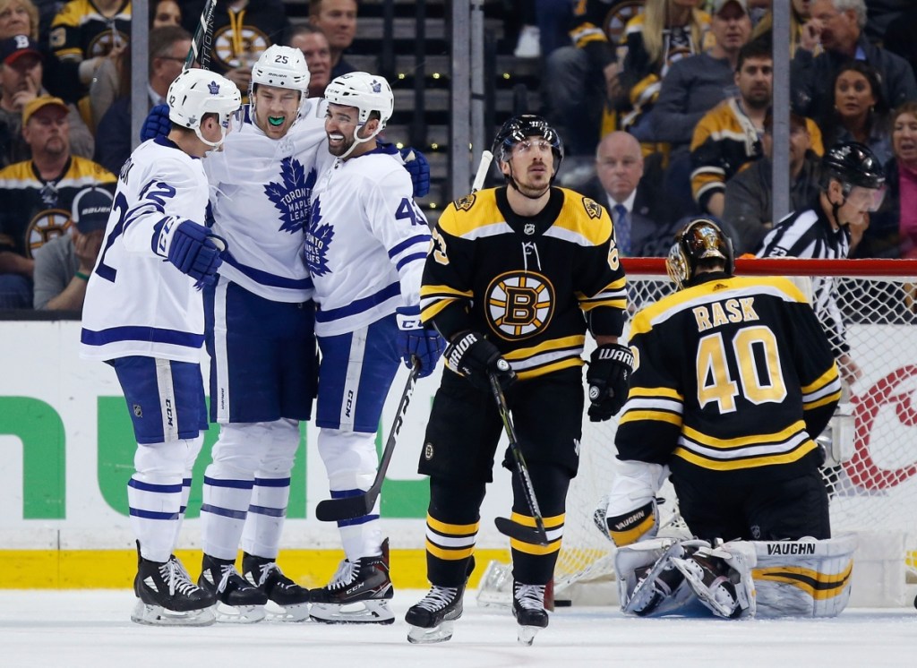 Toronto Maple Leafs' James van Riemsdyk (25) celebrates his goal against Boston Bruins' Tuukka Rask (40), of Finland, with teammates Tyler Bozak (42) and Nazem Kadri (43) during the second period of Game 5 of an NHL hockey first-round playoff series in Boston, Saturday, April 21, 2018. (AP Photo/Michael Dwyer)