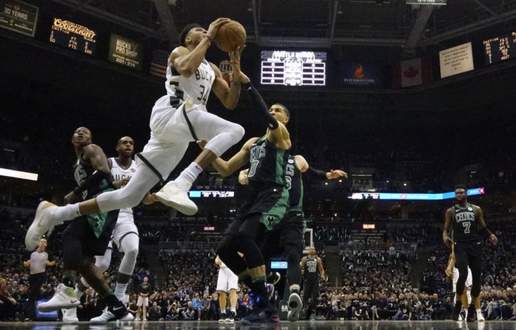 Milwaukee's Giannis Antetokounmpo drives past Boston's Jayson Tatum during Game 4 of their first round series on Sunday in Milwaukee. The Bucks won 104-102 to even the series at 2-2.