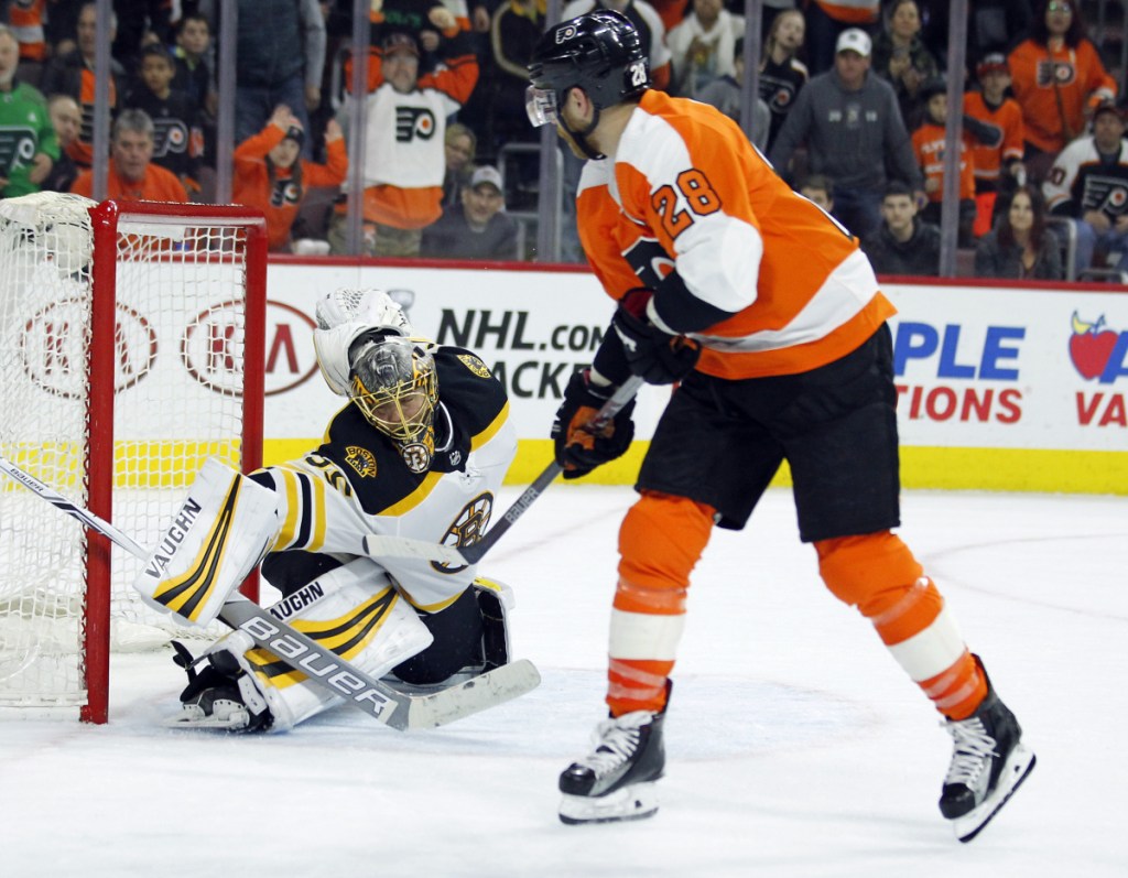 Philadelphia Flyers forward Claude Giroux, right, scores past Boston Bruins goalie Anton Khudobin during overtime in Philadelphia. The Flyers won 4-3.