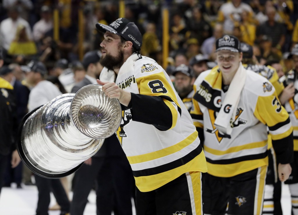 Pittsburgh Penguins defenseman and Biddeford native Brian Dumoulin (8) celebrates with the Stanley Cup after the Penguins defeated the Nashville Predators 2-0 in Game 6 of the hockey Stanley Cup Finals last June in Nashville. The Stanley Cup Playoffs is the most exciting tournament in sports, Travis Lazarczyk writes.