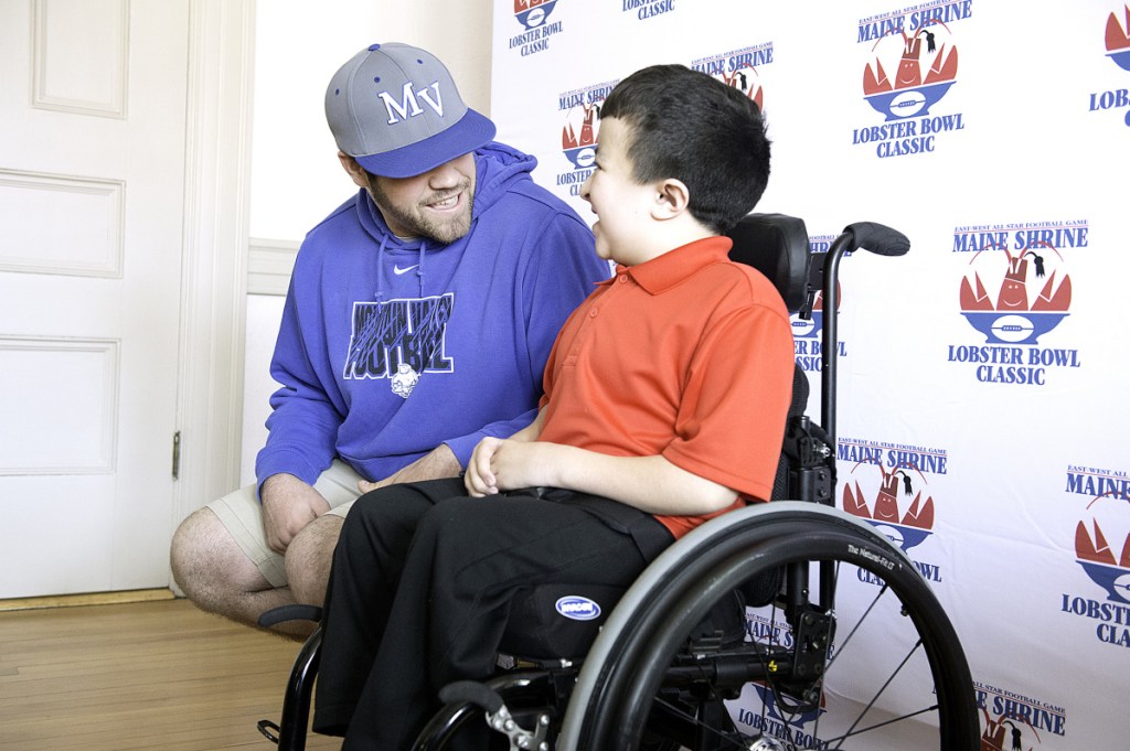 Sun Journal photo by Daryn Slover 
 Mountain Valley High School senior Curtis Gauvin, left, talks with special guest Alec Cabacungan during the annual Maine Shrine Lobster Bowl Classic team meeting Sunday in Lewiston.