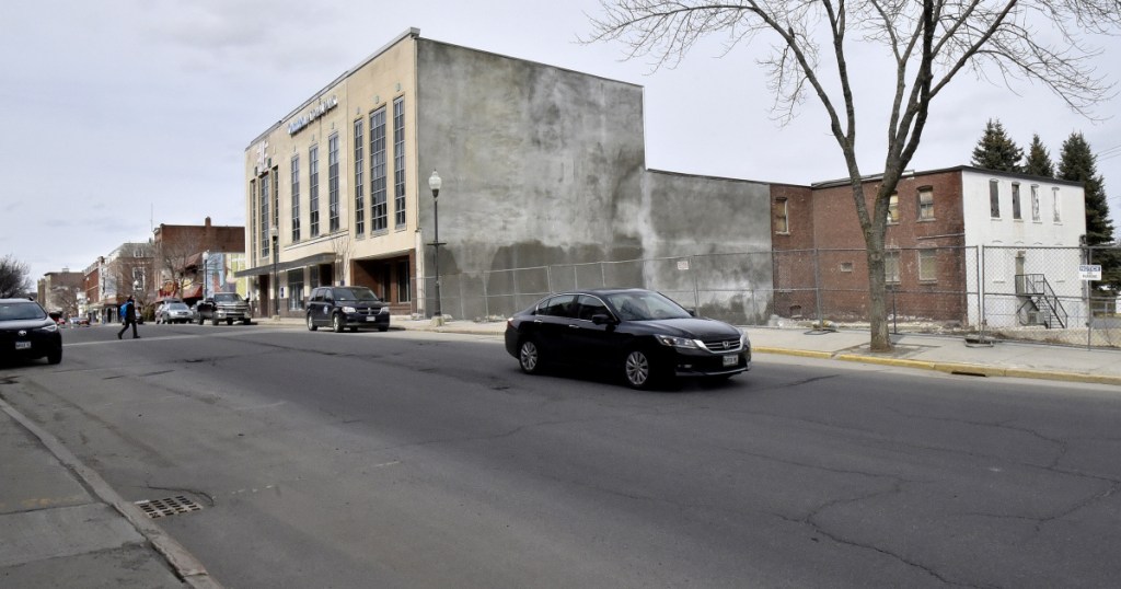 Colby College plans to buy the Camden National Bank building in downtown Waterville and demolish it to make room for a hotel development next door on the former Levine's store site.