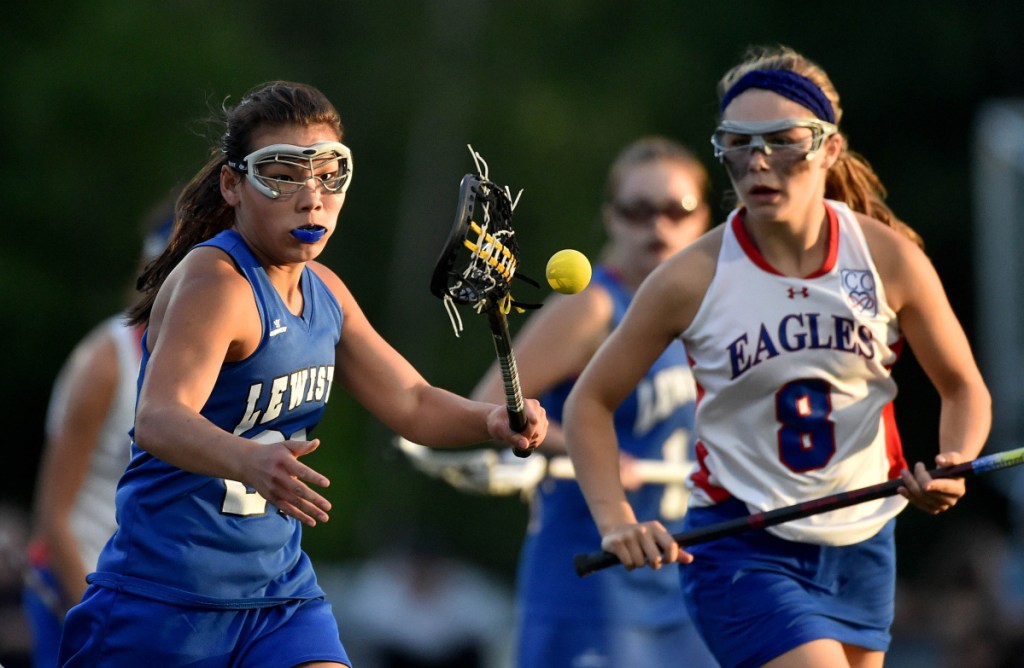 Lewiston's Dacia Bail, left, battles Messalonskee 's Lauren Pickett for a loose ball during the Class A North championship game last season at Thomas College in Waterville.