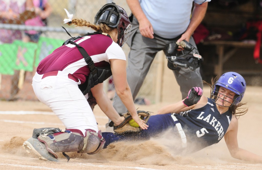 Richmond catcher Sydney Tilton, left, tags Greenville's Aleya Pelletier during the Class D South regional final last season at St. Joseph's College in Standish.