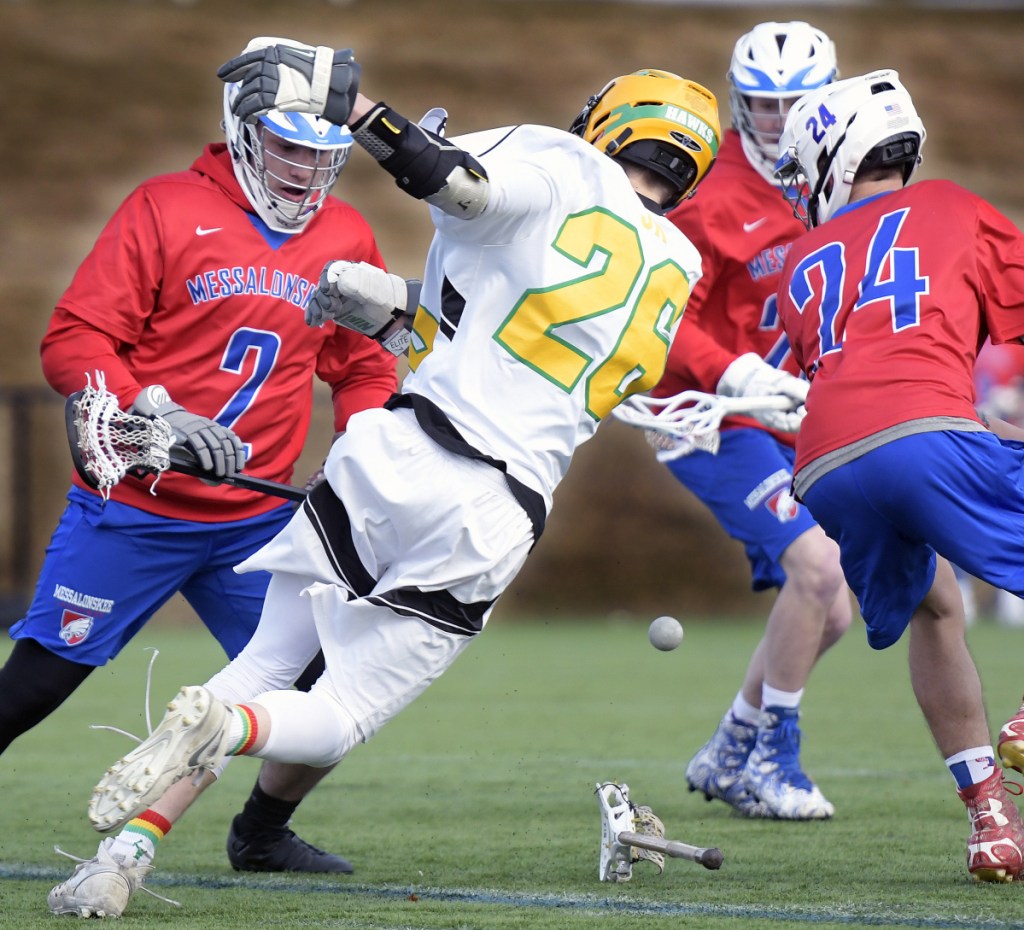 Staff photo by Andy Molloy 
 Maranacook/Winthrop's Owen Austin gets by Messalonskee defenders during a game Tuesday in Readfield.