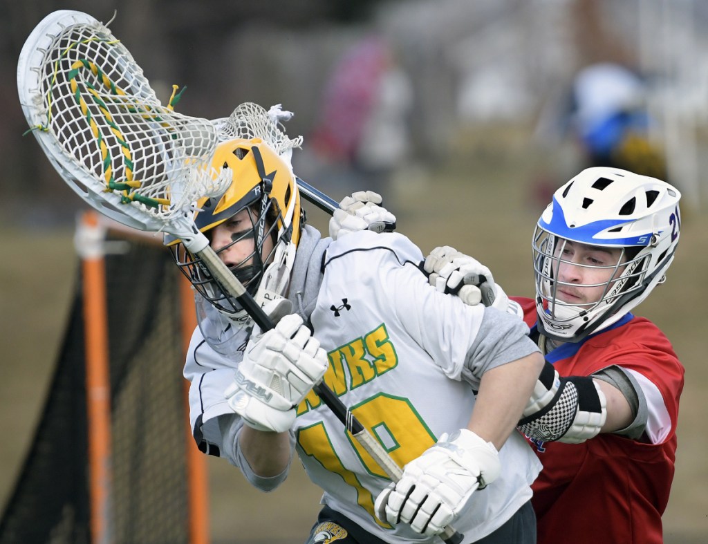 Staff photo by Andy Molloy 
 Maranacook/Winthrop's Will Hays is pursued by Messalonskee's Ryan McCarthy during a game Tuesday in Readfield.