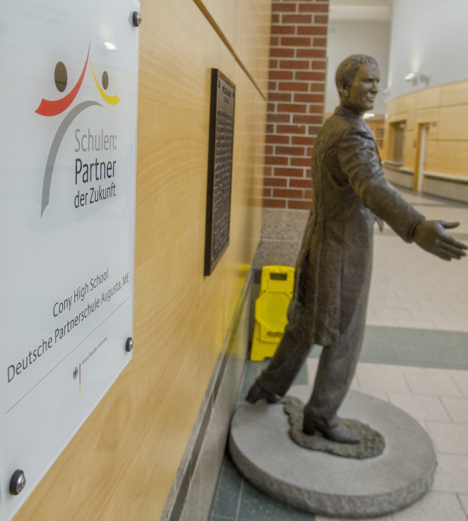 A plaque from the German government recognizing Cony as a partner school hangs beside Daniel Cony statue in lobby on Thursday at Cony High School in Augusta.