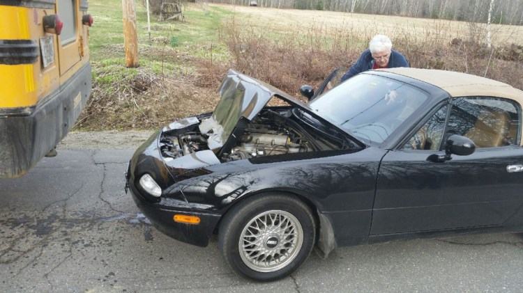 A school bus backed over a Mazda Miata sports car Friday on Industry Road in New Sharon. No injuries were reported.