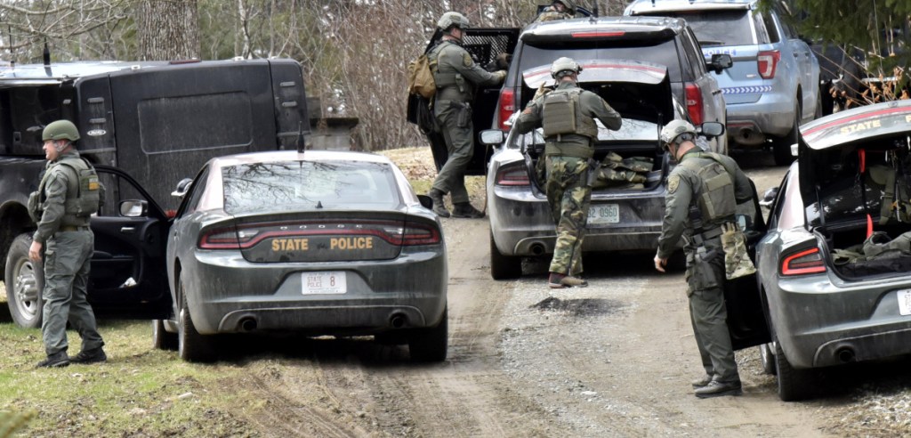 Police converge at a home at 807 Rt. 139 in Fairfield after murder suspect John Williams was apprehended in the woods on Saturday.