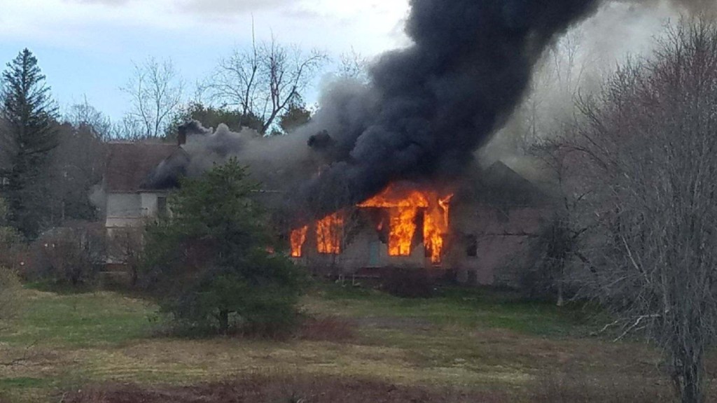 A fire burns a three-story building at 10 West St. in Gardiner on Monday afternoon.