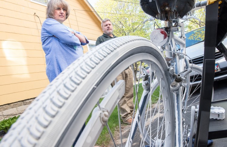 Suzanne and Bob Barton of Westbrook with the "ghost bike" honoring their son, killed by a drunken driver in 1998. Similar painted memorials can be found across the country.