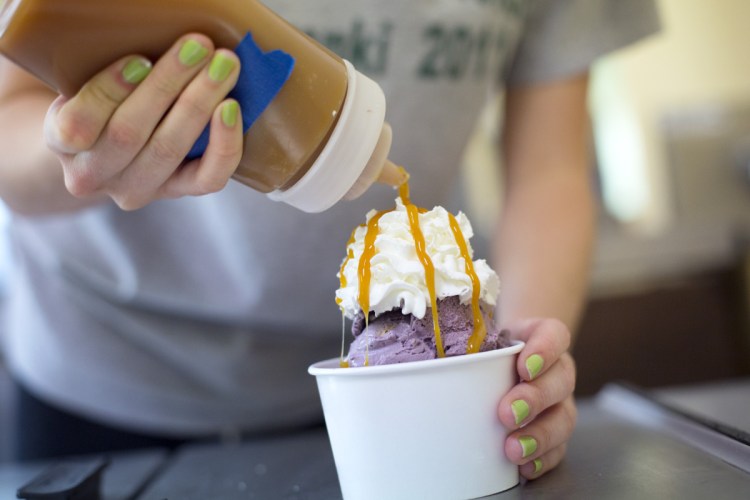 C.J. Logue makes a blueberry pie sundae at Kettle Cove Creamery in Cape Elizabeth on Friday.