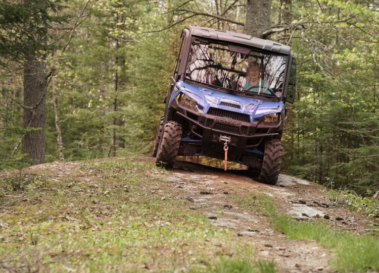 Alicia Cote drives a side-by-side on her family's property in Bowdoin this month. The popular vehicles are larger than ATVs and can take a toll on the land, which could lead to a diminished trail system if private landowners close their property to the off-road vehicles.