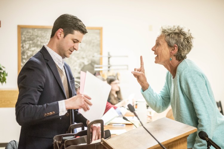 Former Mayor Karen Heck, right, confronts Mayor Nick Isgro on April 17 after a City Vouncil meeting in the council chamber in Waterville. Heck and others led the petition effort to have Isgro ousted from office.