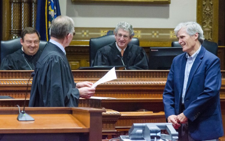 Maine Supreme Court Associate Justice Jeffrey Hjelm, left, presents James McKenna III a Katahdin Counsel award on Thursday during an event in a ceremonial court room at Capital Judicial Center in Augusta.
