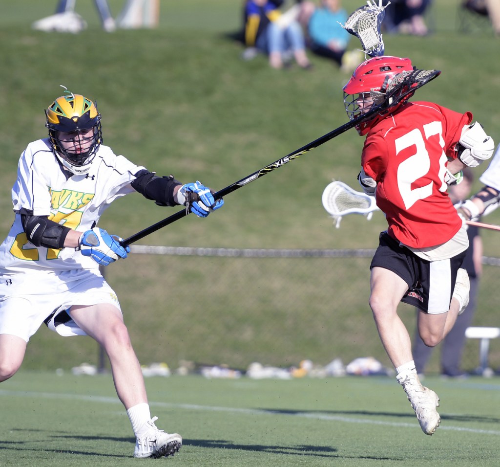 Maranacook/Winthrop's Will Colvin, left, blocks a shot from Cony's Zach Whitney on Tuesday in Kents Hill.