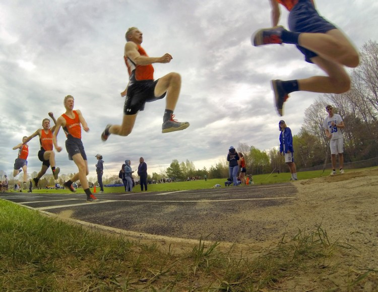 Skowhegan senior Kyle Jacques completes a triple jump during a track and field meet Thursday at Erskine Academy in South China.