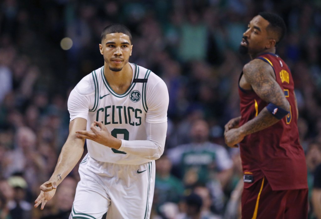 Celtics forward Jayson Tatum celebrates his 3-point basket as Cavaliers guard JR Smith looks on during the second quarter of Boston's 108-83 win in Game 1 of the Eastern Conference finals on Sunday in Boston.