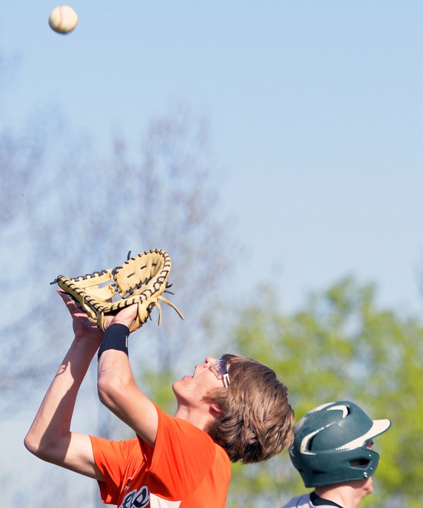 Gardiner senior Alic Shorey prepares to snare a pop up as Leavitt's Eli Lind heads to firts during a Kennebec Valley Athletic Conference Class B game Monday in Gardiner.