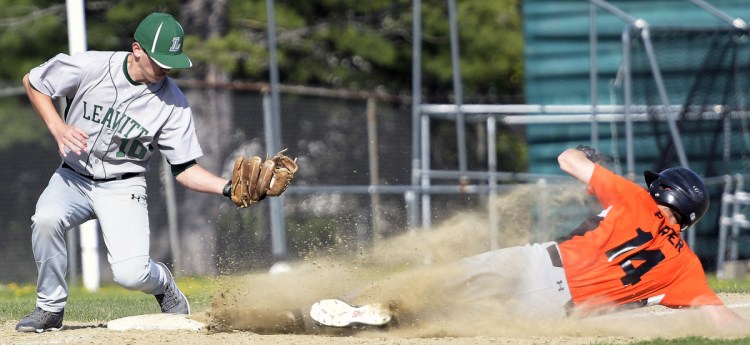 Gardiner senior Logan Porter slides into third ahead of a throw to Leavitt's Austin Tayler during a Kennebec Valley Athletic Conference Class B game Monday in Gardiner.