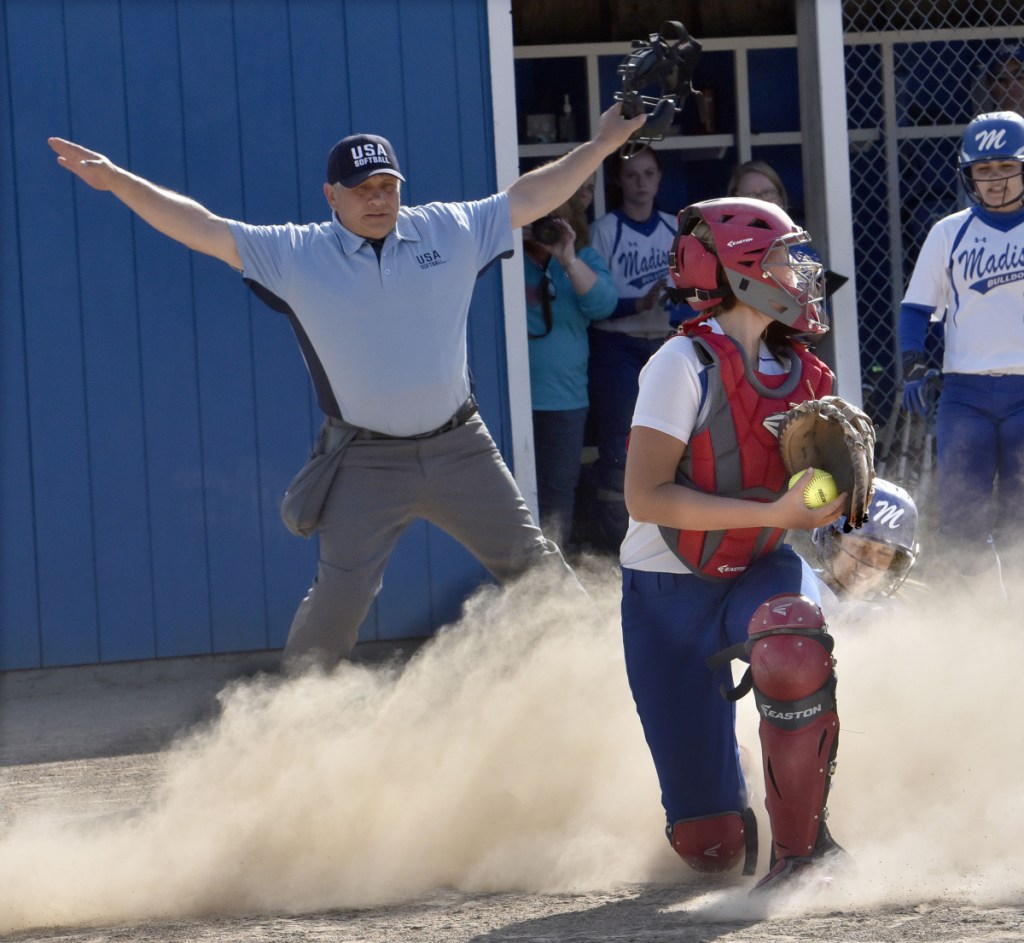 Madison senior Sydney LeBlanc slides safely into home as Oak Hill catcher Abby Nadeau applies the tag during a Mountain Valley Conference game Monday afternoon in Madison.