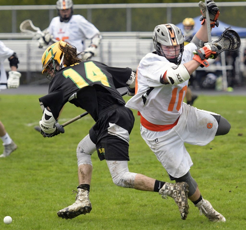 Gardiner's Tanner Hebert, right, leaps around Maranacook/Winthrop's Jacob Sousa on Tuesday in Gardiner.