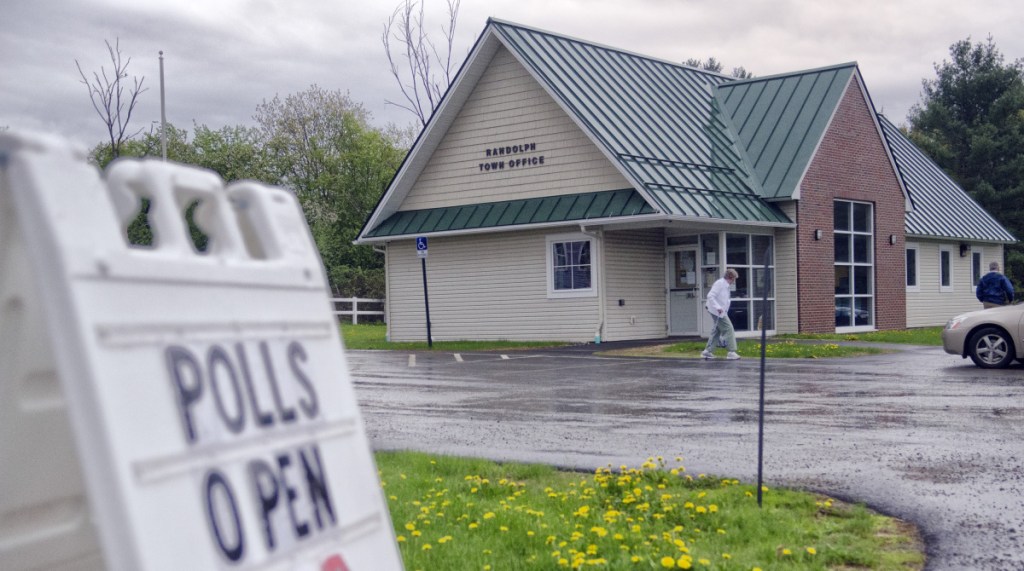 People walk back to their cars Tuesday after voting in a referendum at the Randolph Town Office. Randolph residents were voting on whether to close T.C. Hamlin School.