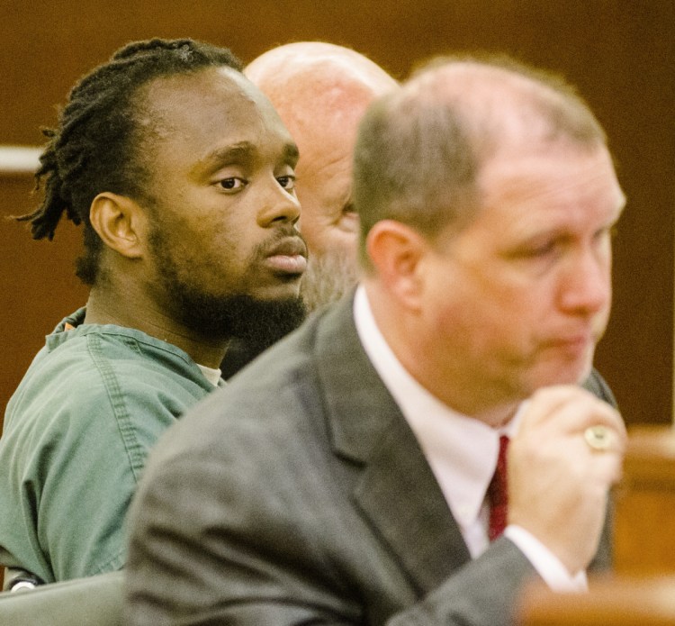 Aubrey N. Armstrong, one of four people charged in the Nov. 23, 2015, drug-related beating death of Joseph Marceau in an Augusta apartment, left, looks at his attorney, Brad Grant, during the opening day of trial Tuesday at the Capital Judicial Center in Augusta.