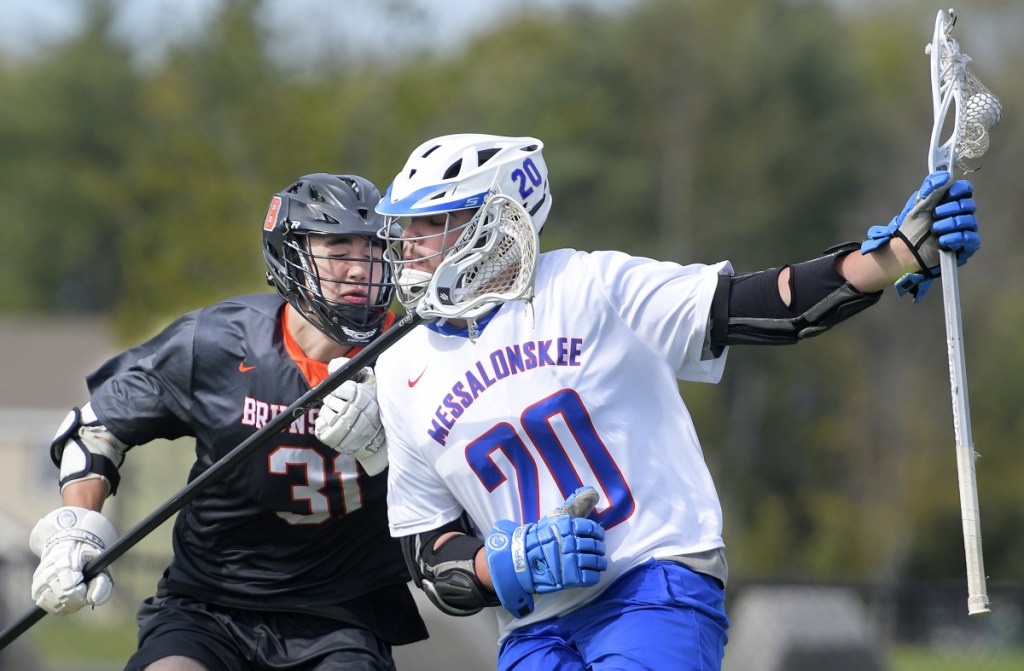 Messalonskee's Colin Kinney, right, gets clipped by Brunswick's Sam Dorval during a game Wednesday in Waterville.