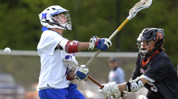 Messalonskee's Dan Gusmanov is blocked by Brunswick's Aiden Glover during a game in Waterville on Wednesday.