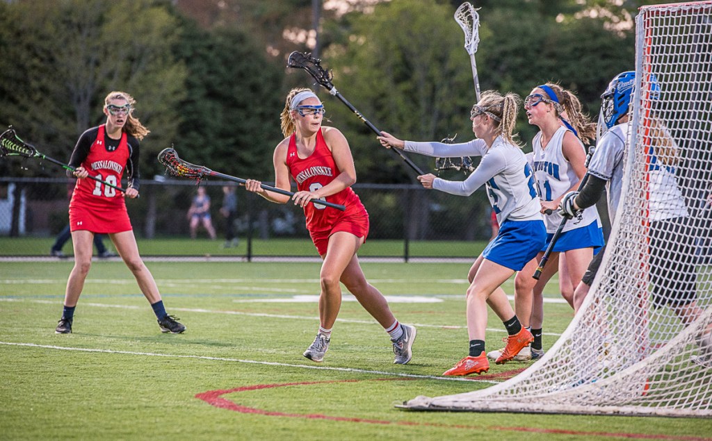 Messalonskee's Lauren Pickett looks for a hole in Lewiston's defense during Wednesday night's lacrosse game at Bates College in Lewiston.