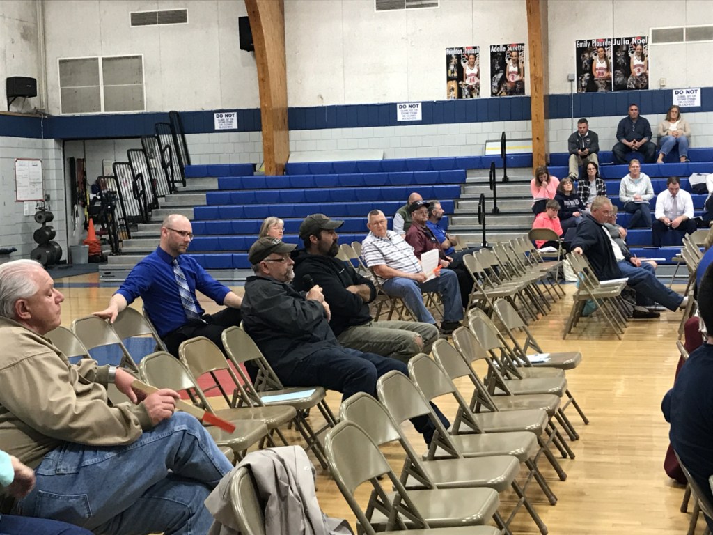 Mark Russell, chairman of the Litchfield Select Board, speaks at the district budget meeting of Regional School Unit 4 on Wednesday at Oak Hill High School. Russell expressed frustration with the district's funding formula, which he said places an unfair amount of the tax burden on Litchfield, and unsuccessfully proposed multiple amendments to lower the proposed budget.