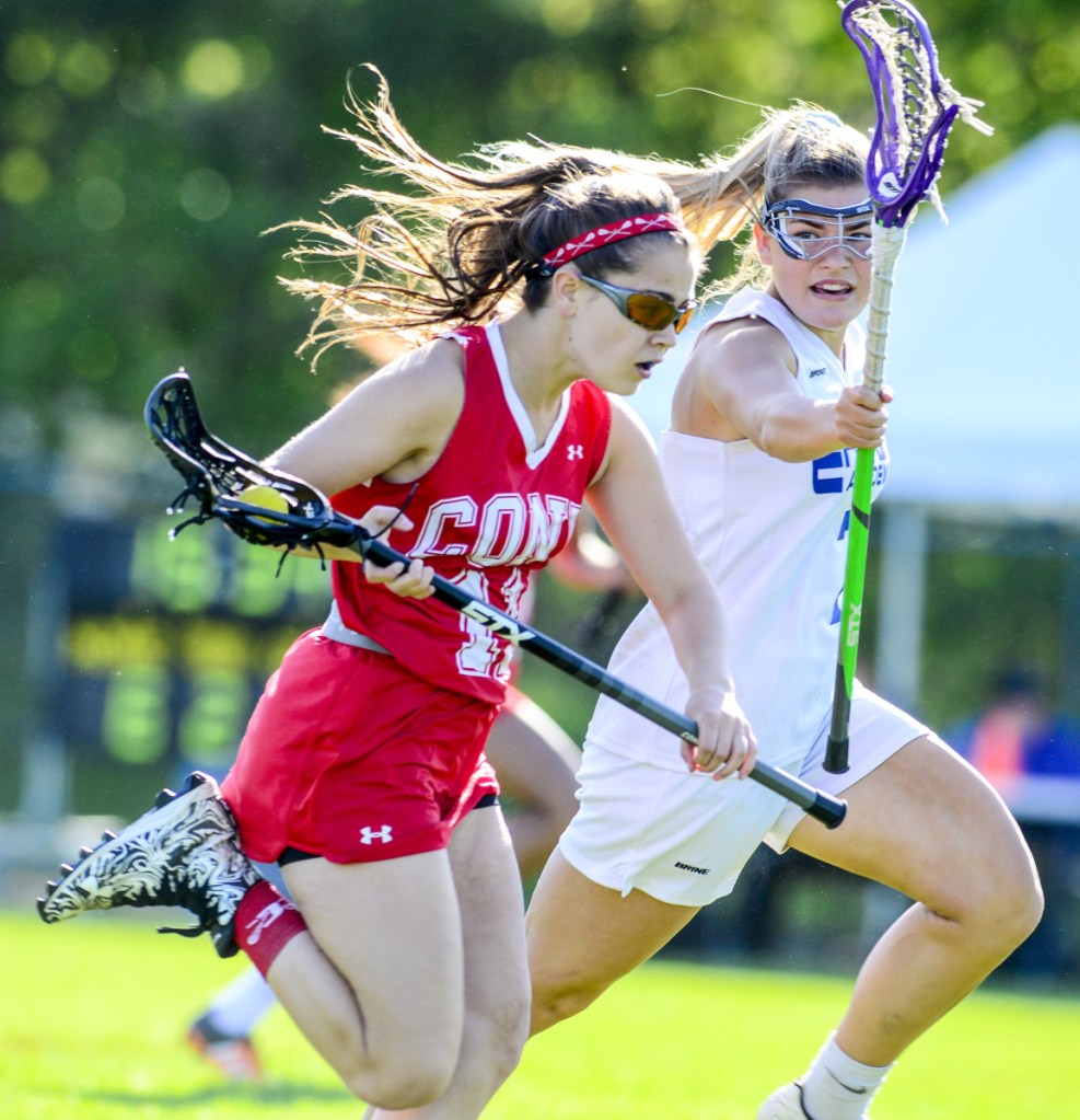 Cony's Faith Leathers-Pouliot races up field as Erskine Academy's Morgan Emond tries to stop her during a game Wednesday at Erskine Academy.