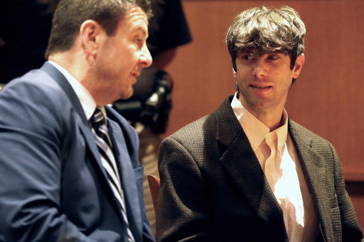 John D. Williams, right, who is accused of killing Somerset County Deputy Cpl. Eugene Cole, talks with his lawyer Verne Paradie before pleading not guilty Tuesday during his arraignment in the Cumberland County Courthouse.