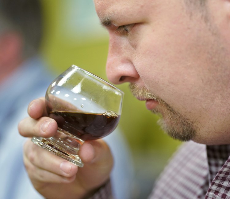 Benkei O'Sullivan, general manager of Bolster, Snow and Co., takes in the aroma of a coffee blend while at Coffee by Design working to develop a signature coffee for the restaurant and The Francis Hotel.