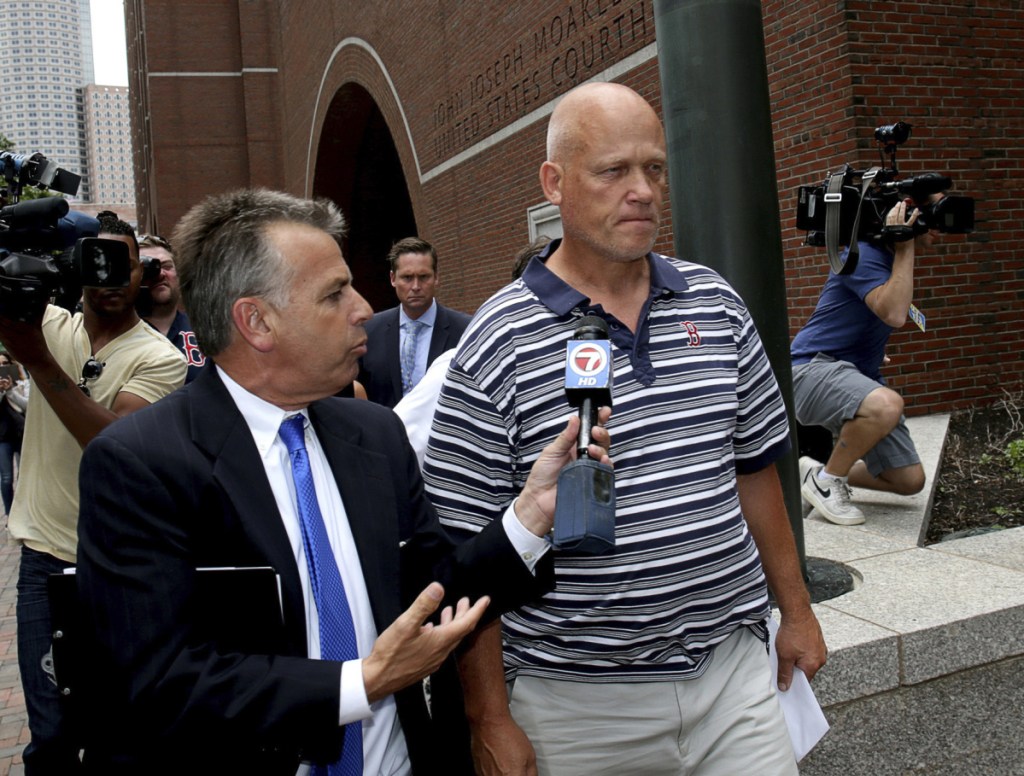 Retired Massachusetts State Police Trooper David Wilson leaves the Moakley Federal Courthouse on Wednesday in Boston. He is accused of receiving $12,500 in fraudulent pay.