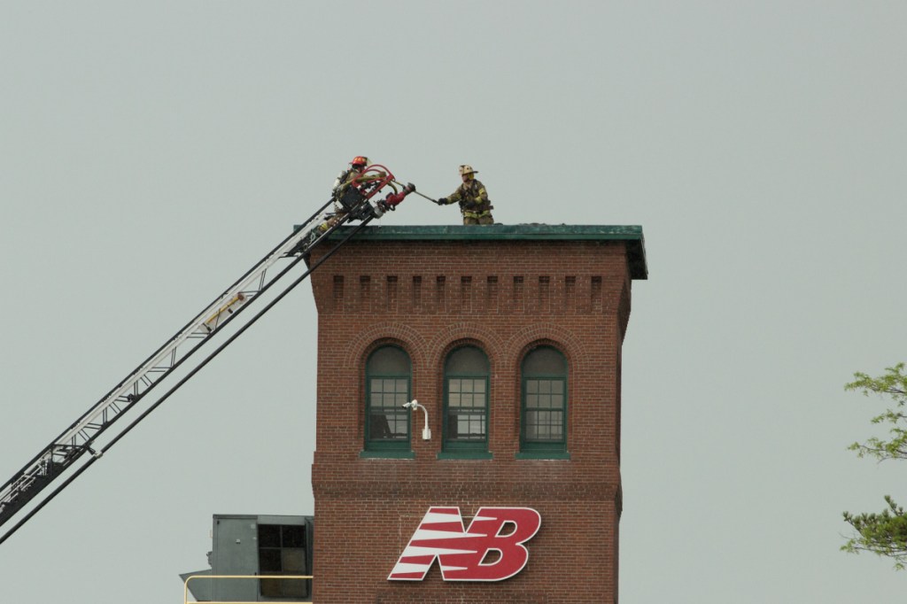 Firefighters battle a fire at the New Balance factory in Skowhegan on Friday.