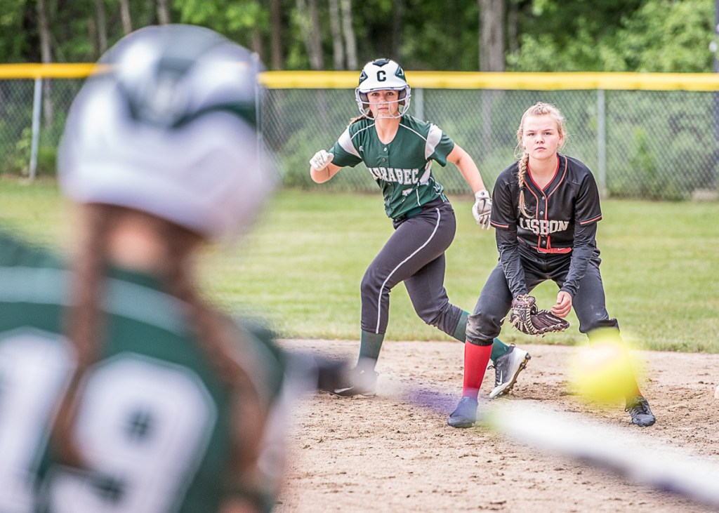 Carrabec baserunner Mackenzie Baker and Lisbon infielder Kiley Merritt keep an eye on Carrabec batter Ashley Cates during a Class C South quarterfinal game Wednesday.