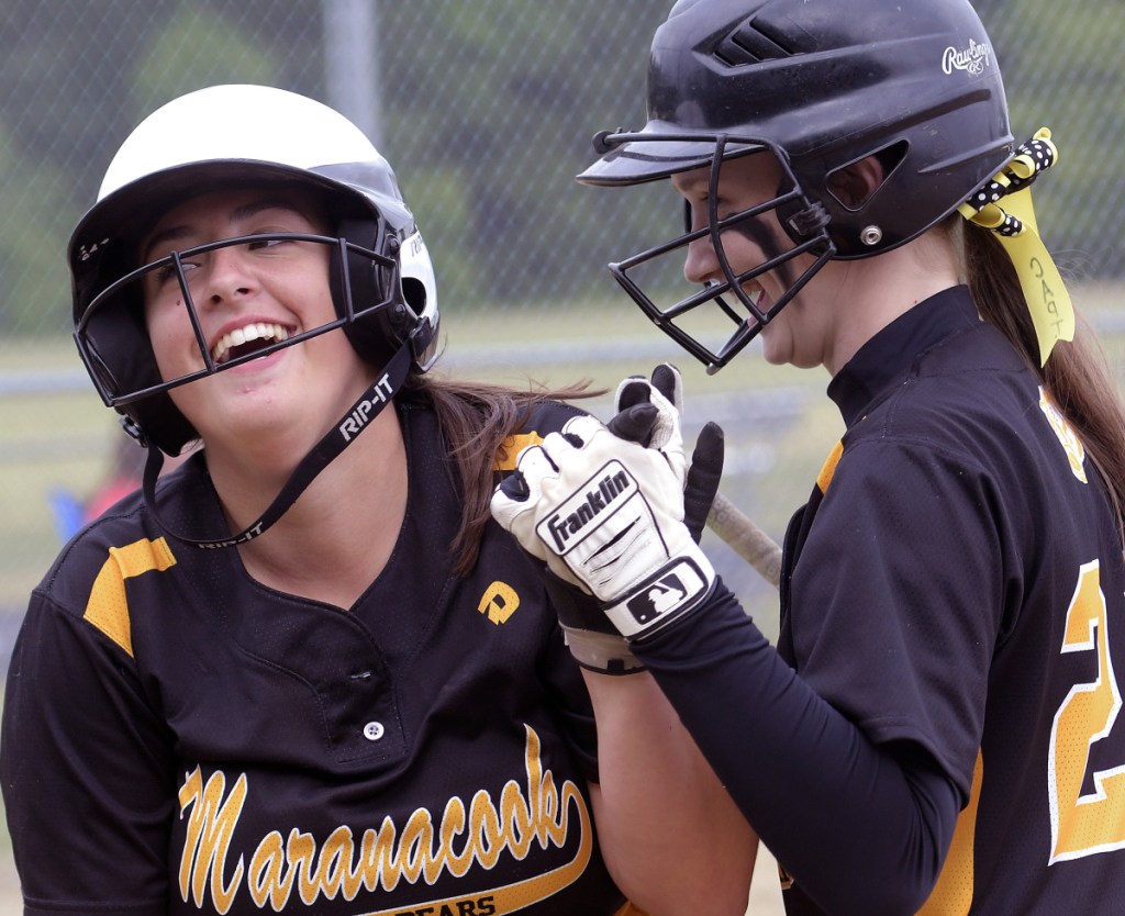 Staff photo by Andy Molloy 
 Maranacook's Erin Bonenfant greets Amanda Goucher at home during a Class C South prelim game against Hall-Dale on Wednesday in Farmingdale.