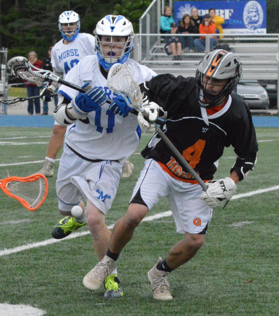 Gardiner's Nathan Phillis (4) goes for a loose ball in front of Morse's Giage Kindlemann during a Class B prelim game Wednesday night in Bath.