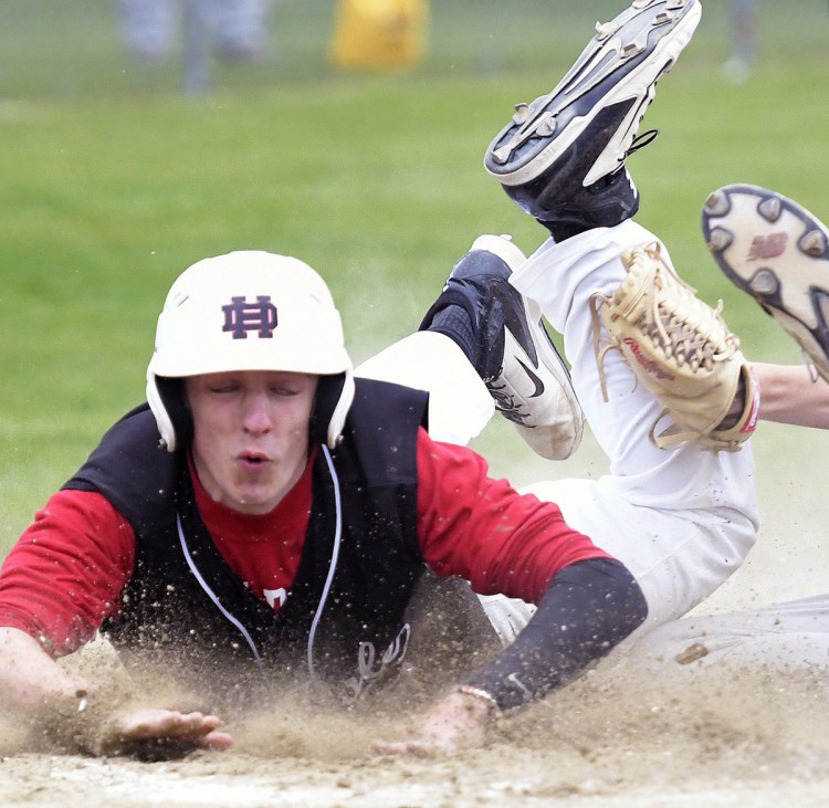 Hall-Dale's Jett Boyer gets tagged by Winthrop's Greg Fay at home during a Class C South quarterfinal game Thursday in Farmingdale.